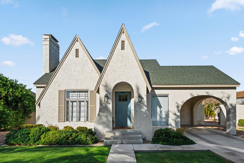 A house with a green roof and a grey front door.