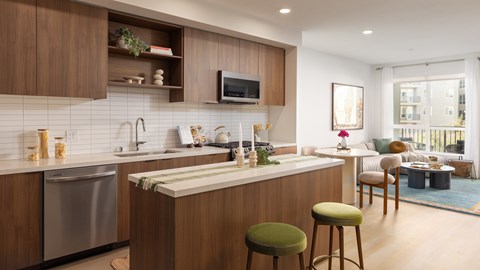 A modern kitchen with wooden cabinets and a central island.