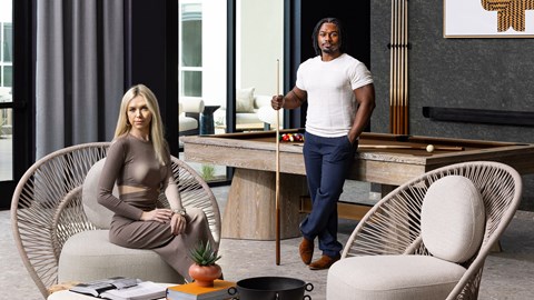 A man and a woman are in a room with a pool table.