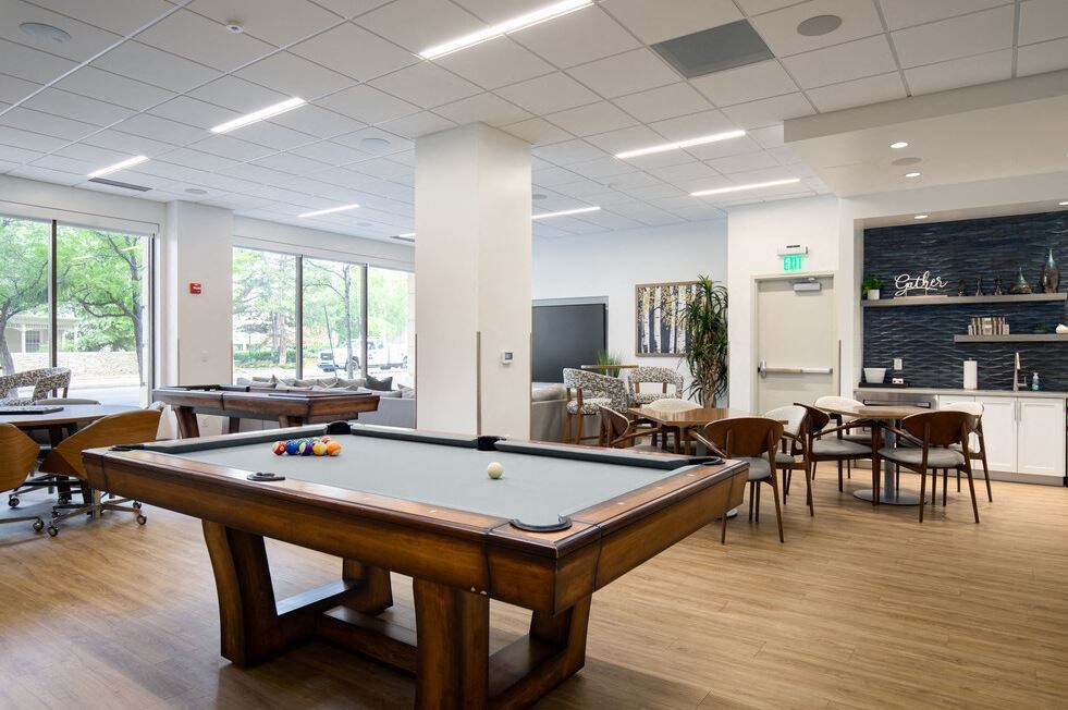 Game room with pool table and seating areas