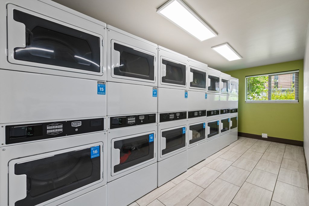 A row of ovens are lined up in a room.
