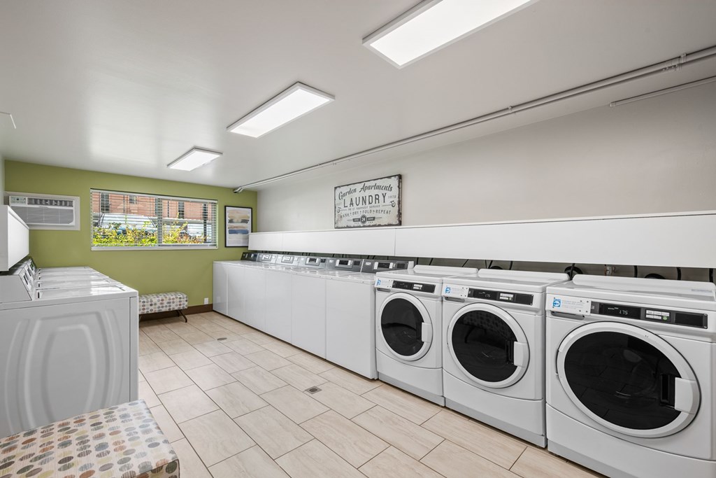 A row of washing machines in a laundry room.