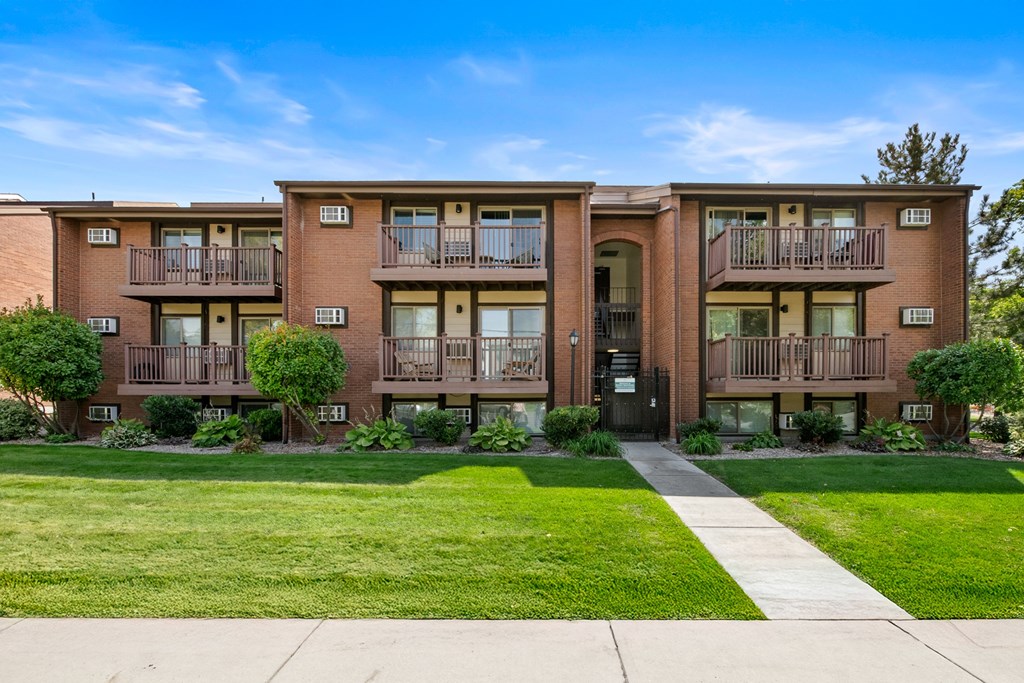 Apartment building with a green lawn in front.