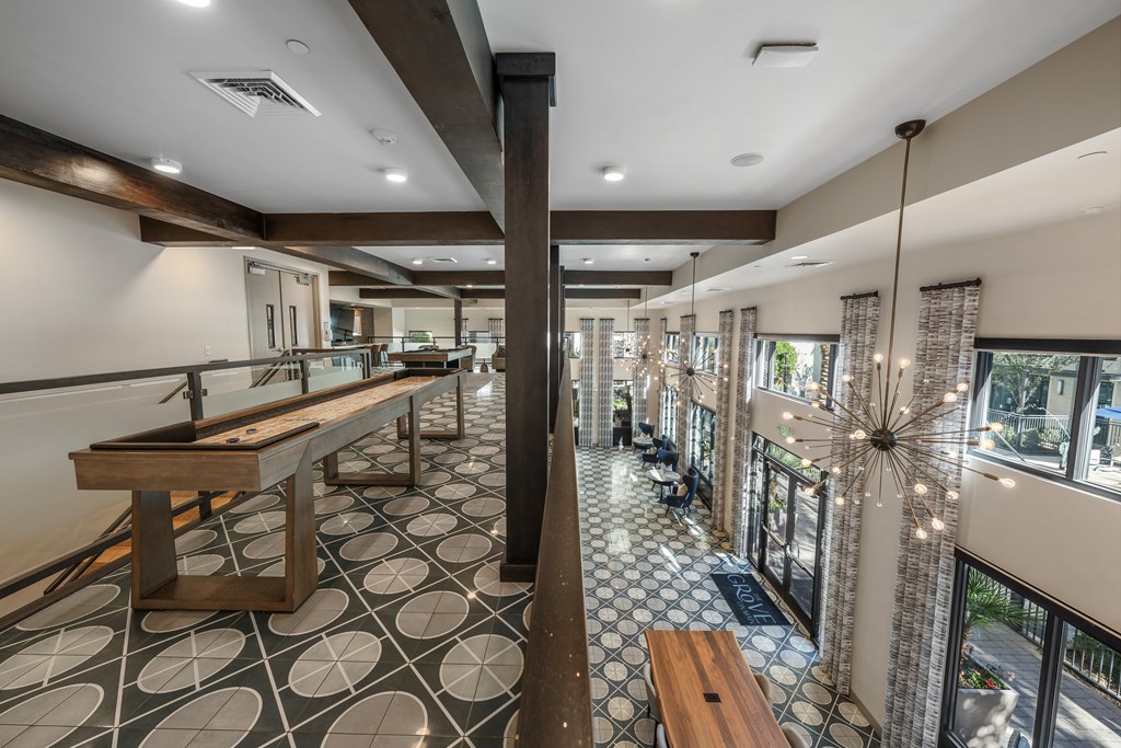 a large room with a bar and tables in it