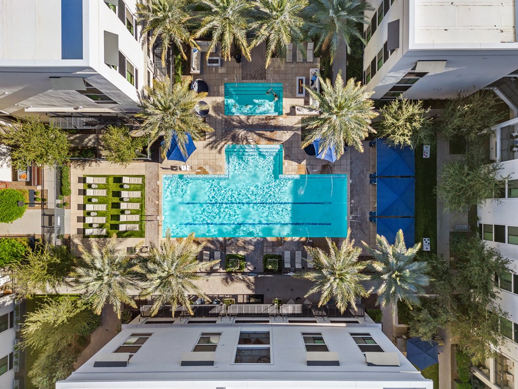 a birds eye view of a hotel with palm trees