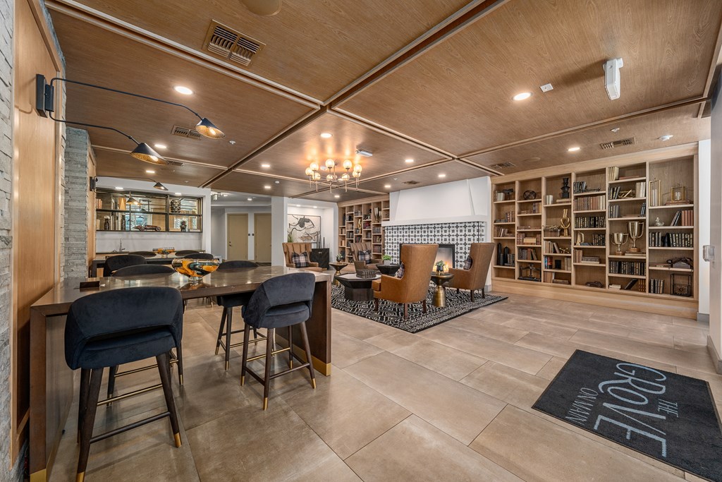 a living room and dining room with a table and chairs