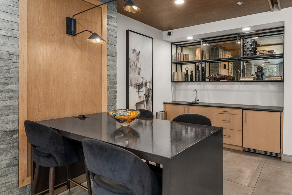 a dining room with a table and chairs and a kitchen