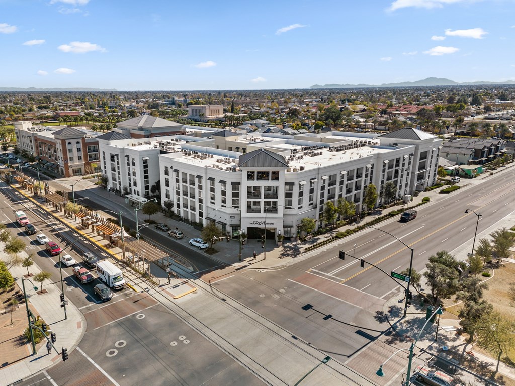 an aerial view of a city street with buildings and cars