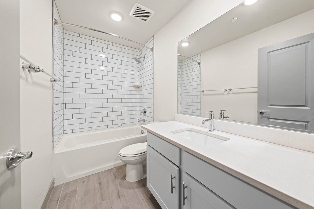 A white bathroom with a white toilet and a white sink.