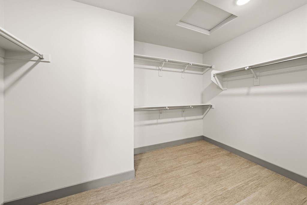 Empty room with white walls and wooden floor.