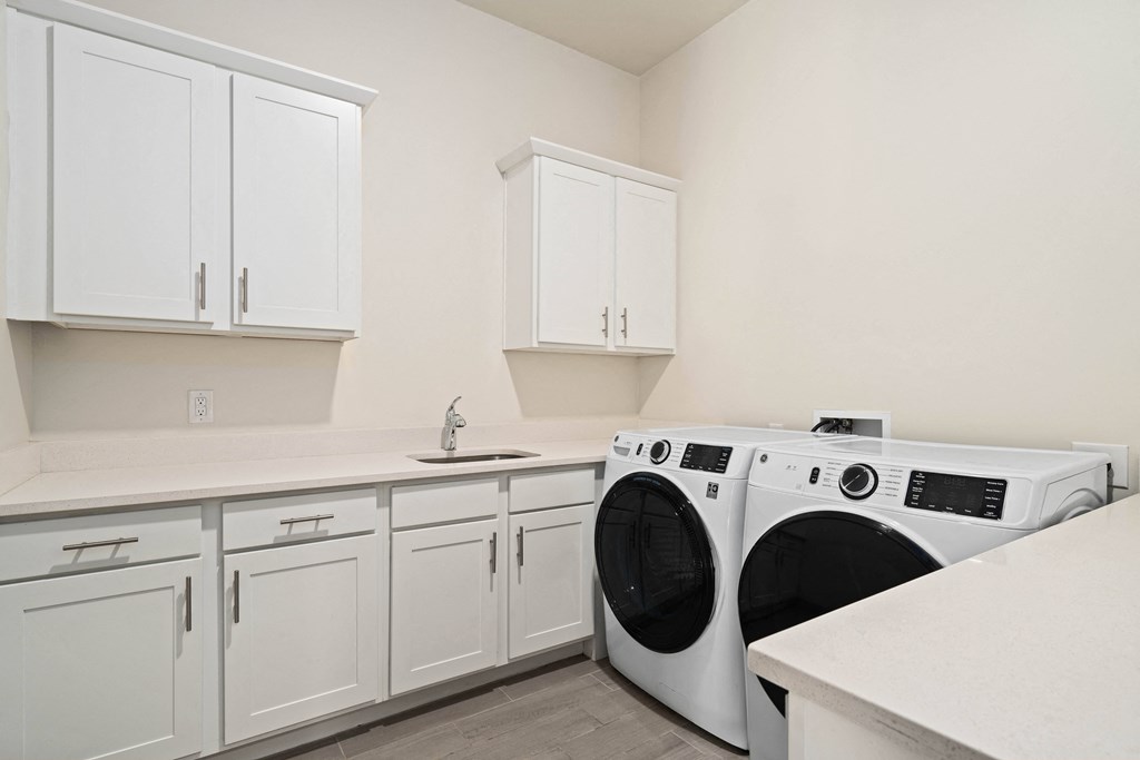 A white laundry room with a washer and dryer.