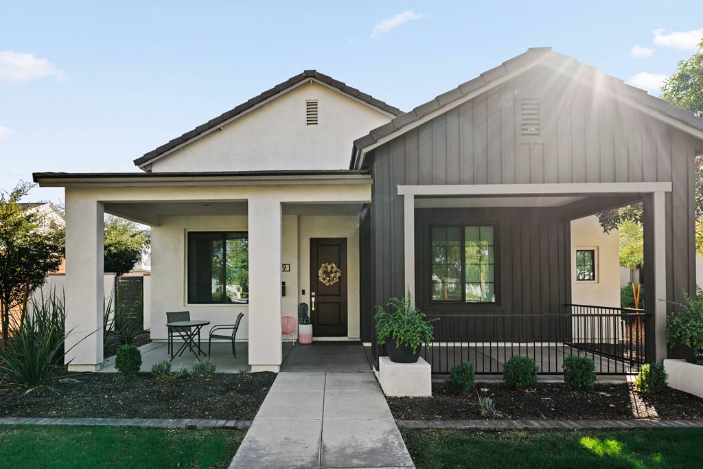A modern house with a front porch and a covered entryway.