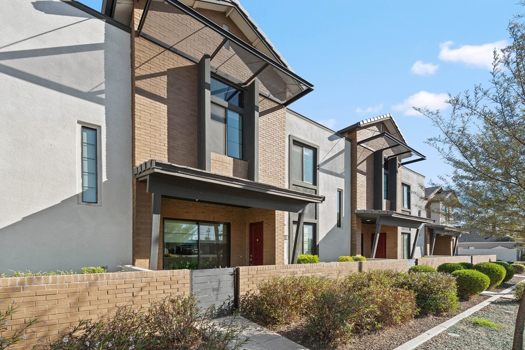 A modern house with a brown and beige exterior.