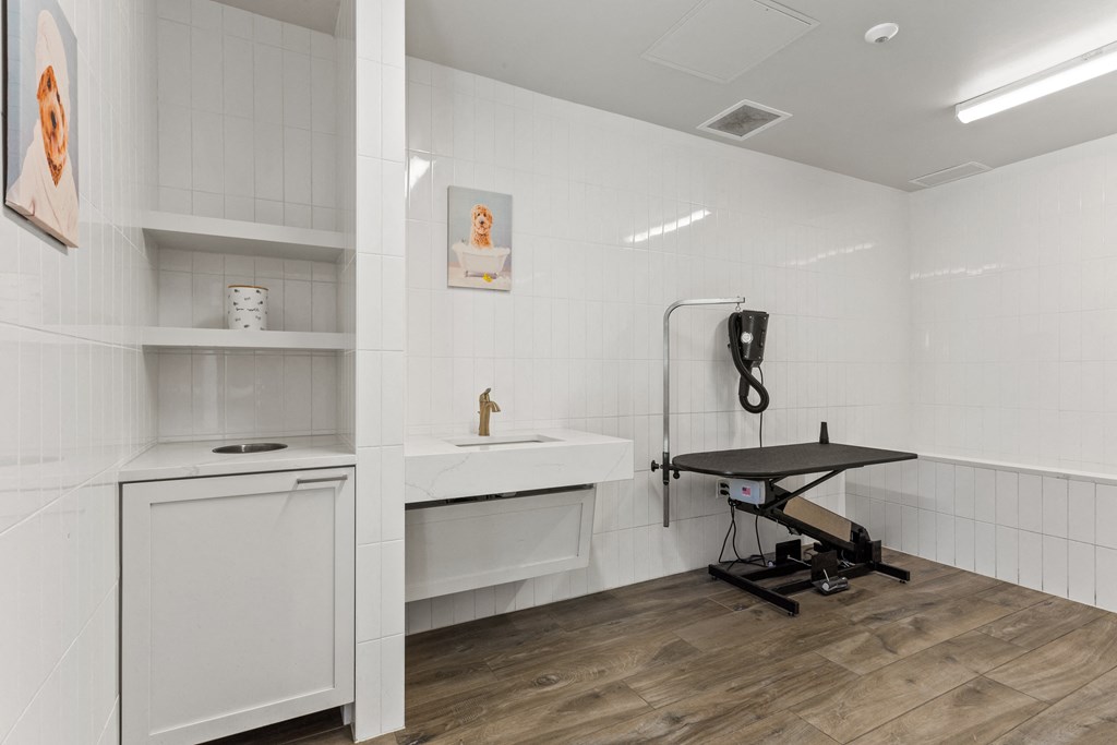 A bathroom with a sink, a cabinet, and a table.