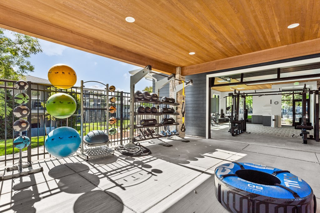 A gym with a variety of equipment including a blue exercise ball.