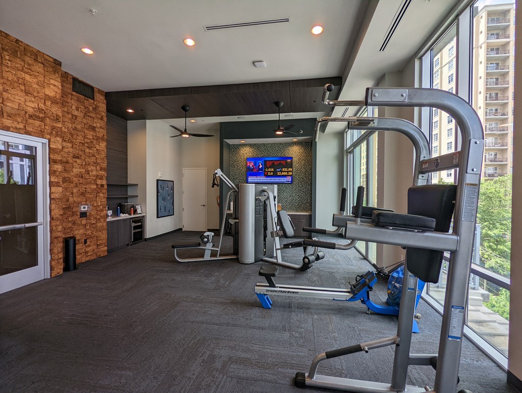 a gym with exercise equipment and a large window