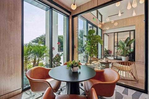 A modern dining area with a round table and chairs.
