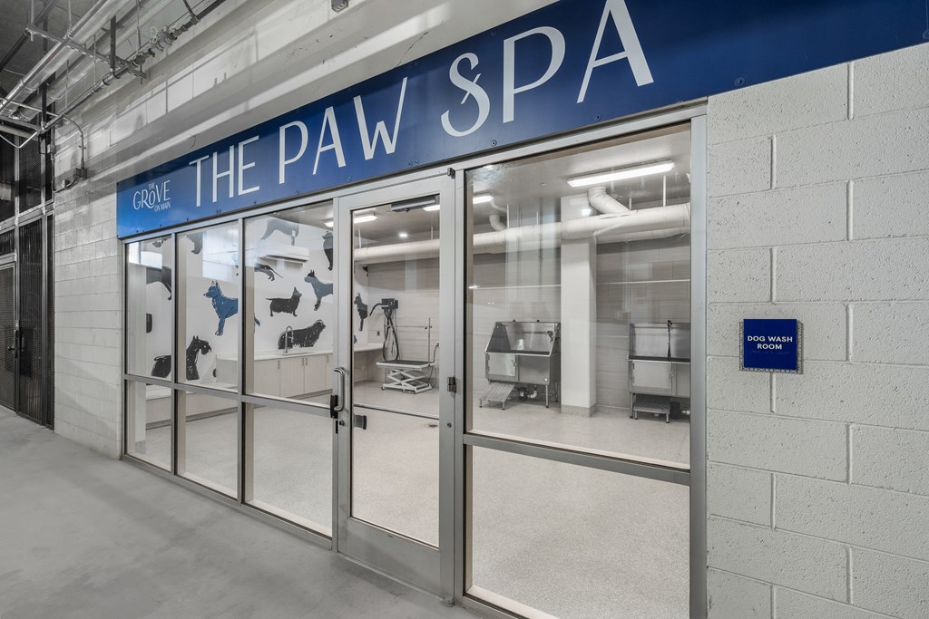 the pav spa entrance with glass doors and a blue sign on the wall