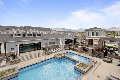 a large swimming pool with a building in the background