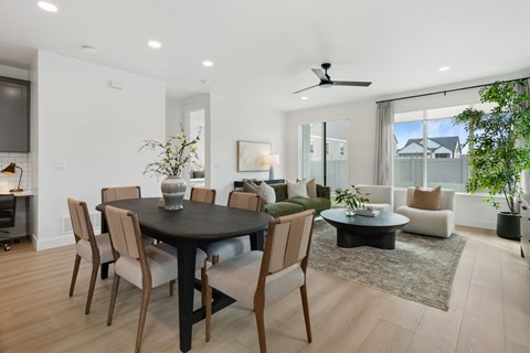 A modern dining room with a round table and chairs.