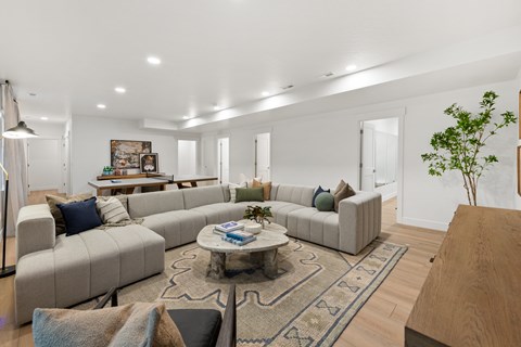 A living room with a grey sofa set and a coffee table.