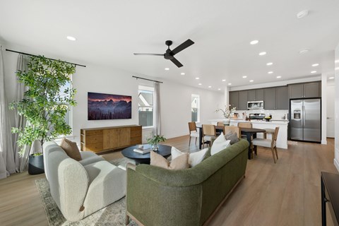 A modern living room with a green couch and a wooden coffee table.