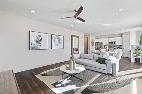 A modern living room with a white sofa and a coffee table.