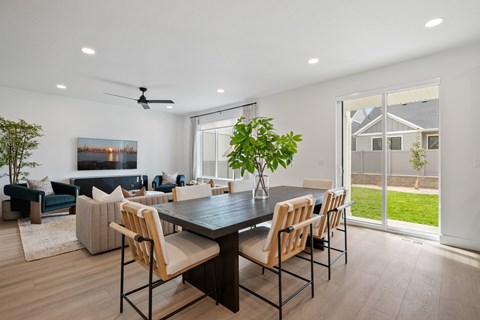 A modern dining room with a large table and chairs.
