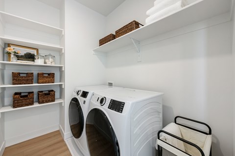 A white laundry room with a washer and dryer.