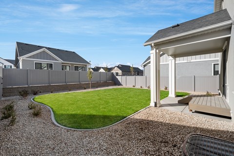 A house with a grey roof and a white garage door.