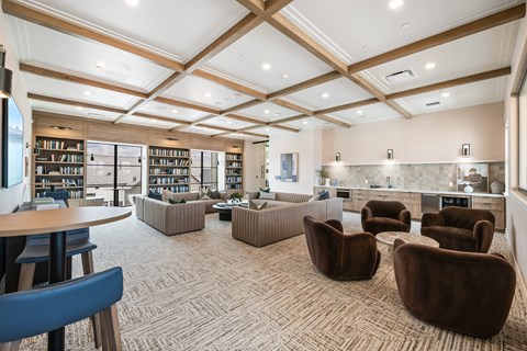 A room with a carpeted floor and a ceiling with wooden beams.