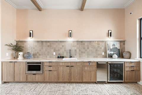 A kitchen with wooden cabinets and a tile backsplash.