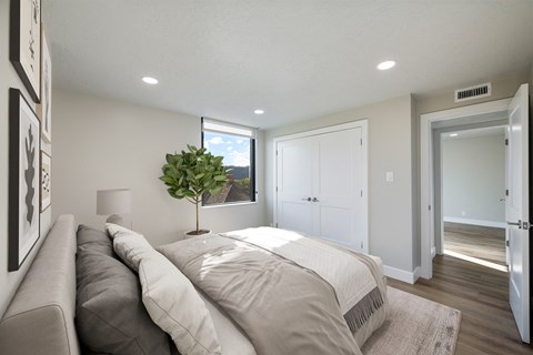 A bedroom with a large bed and a couch.
