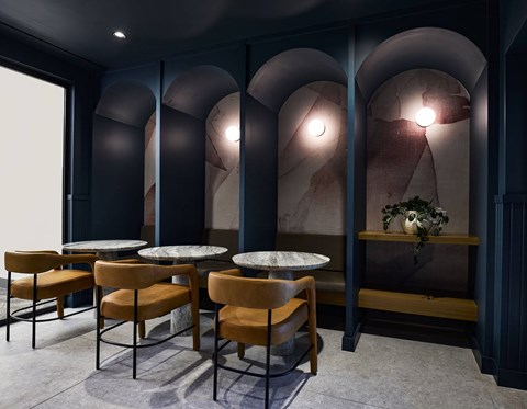 A dining room with a table and chairs.