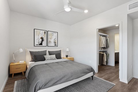 Three-Bedroom Apartments in Lake Oswego, OR - Kruseway Commons - A Bedroom with Wood-Inspired Flooring, a Ceiling Fan, and Nightstands with Lamps.