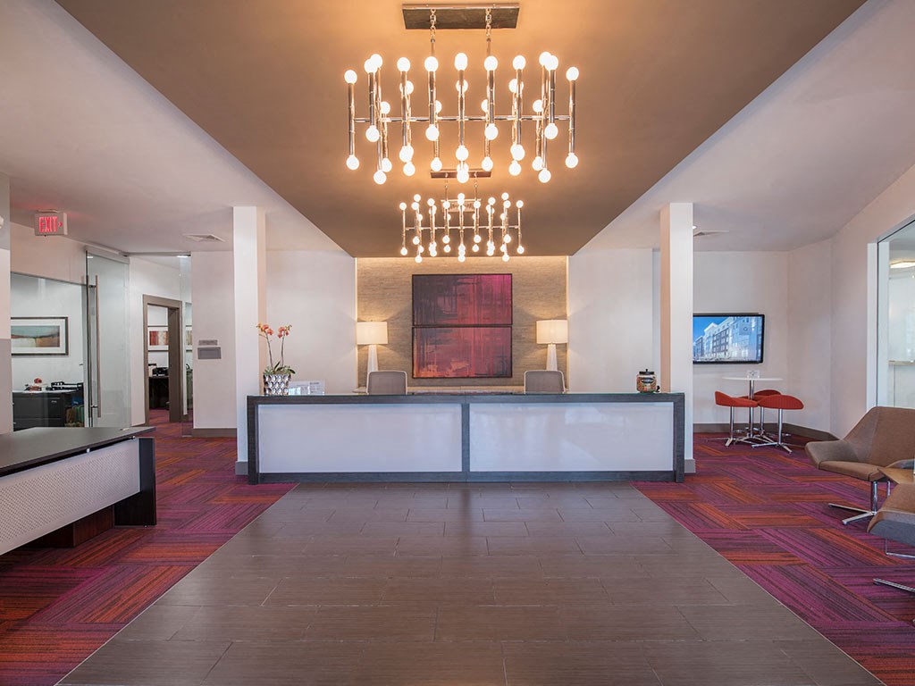 Atmark leasing office and lobby with a reception desk and a chandelier
