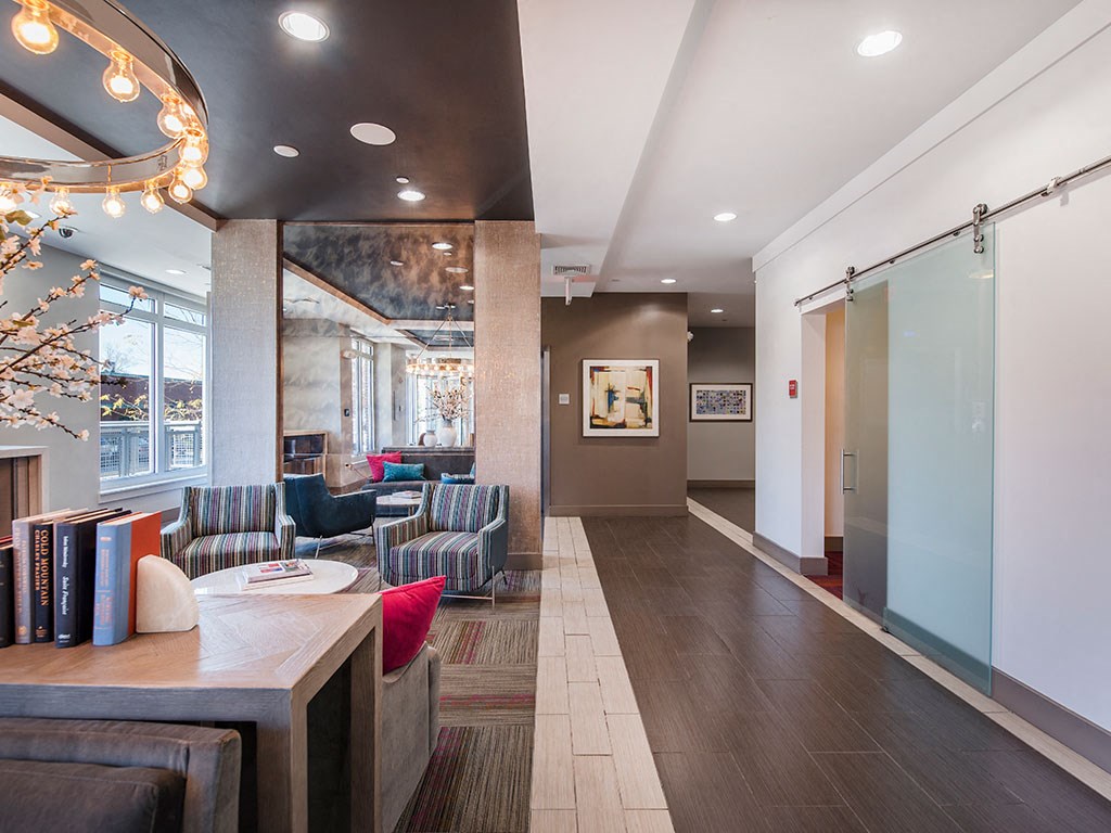 Lobby at Atmark with couch seating, and private work from home rooms