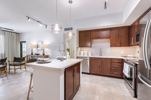 A modern kitchen with wooden cabinets and stainless steel appliances.