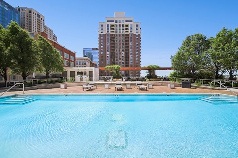 Luxury outdoor pool with lounge seating and skyline views at South Loop Chicago apartments