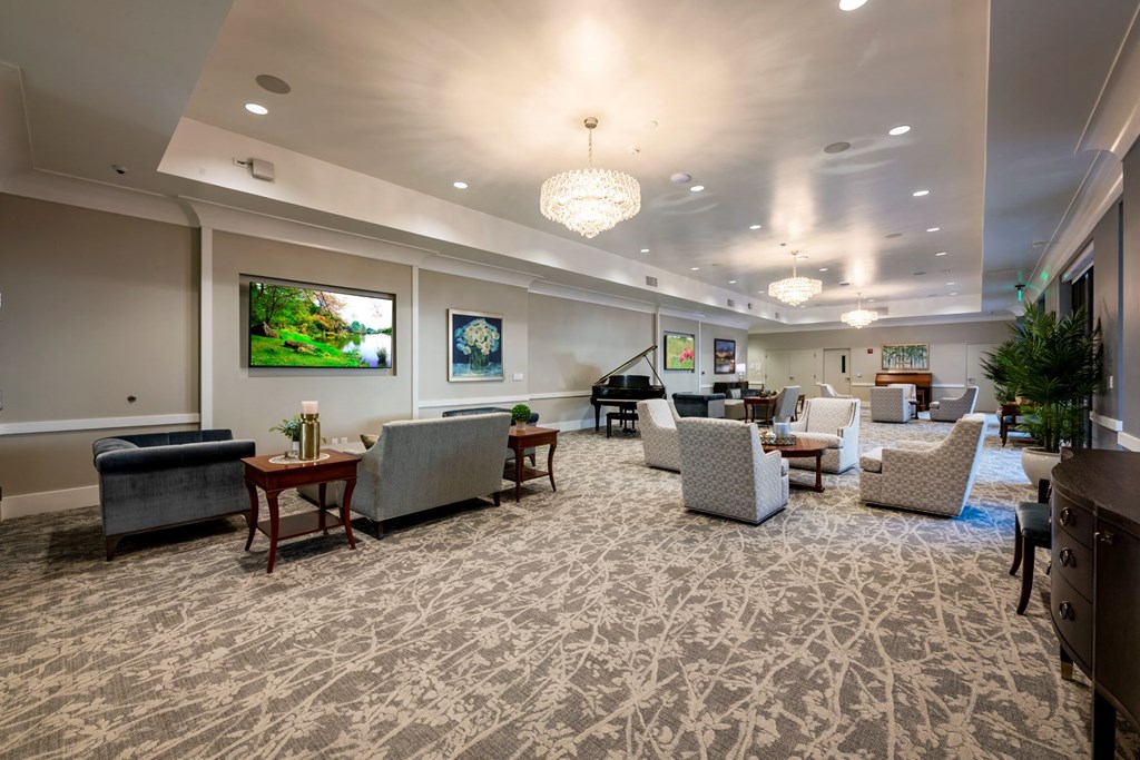 Social room with seating and carpet flooring