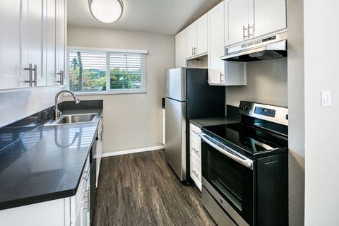 Stainless steel appliances including built-in microwave, refrigerator, and dishwasher at 1038 on Second, California, 94549
