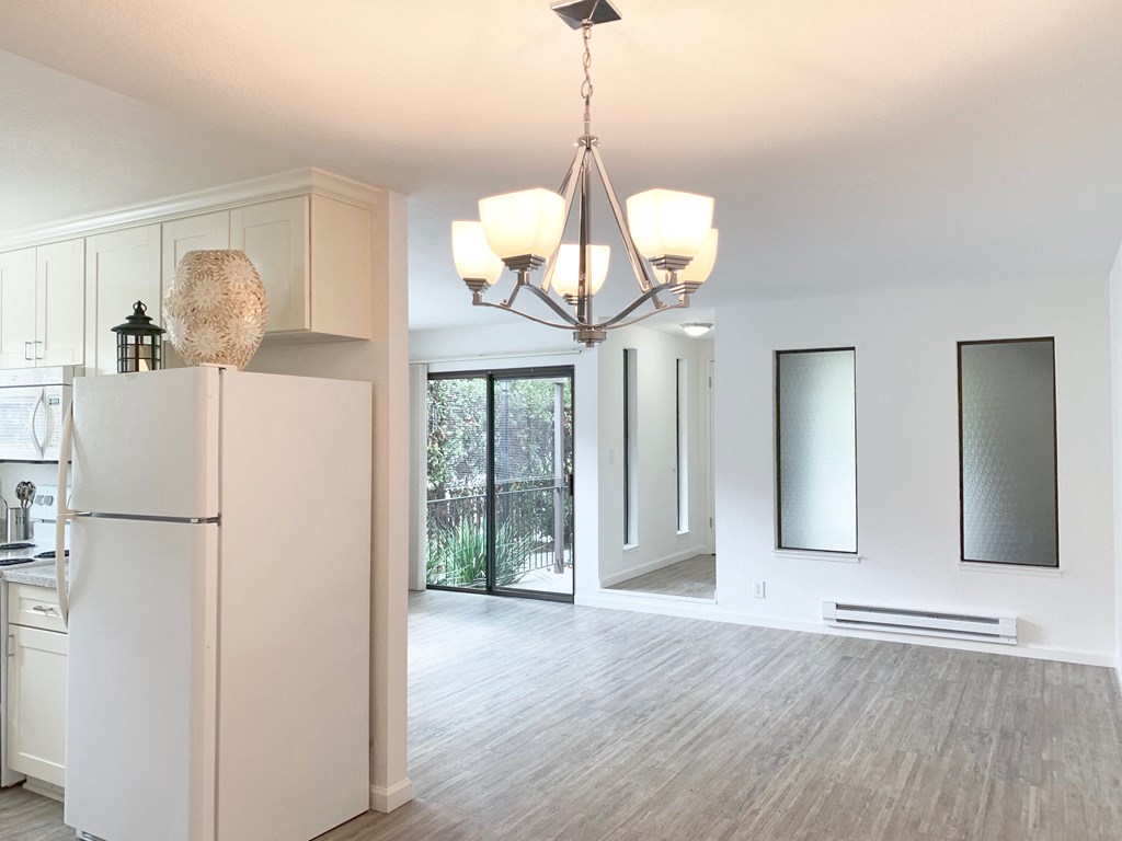 Kitchen with fridge near living roomat Park Avenue Apartments, San Jose, CA