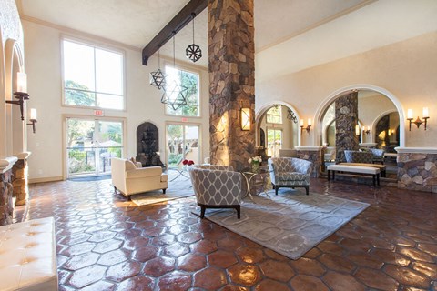 a large living room with a stone fireplace and furniture