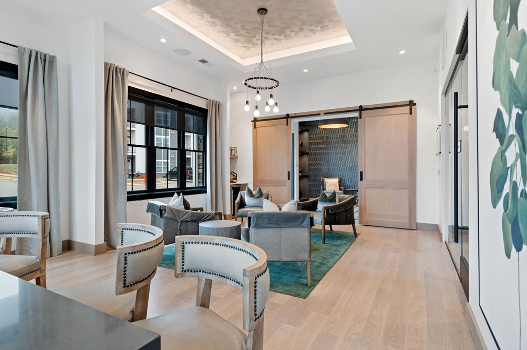 A modern living room with a grey sofa set and a wooden floor.