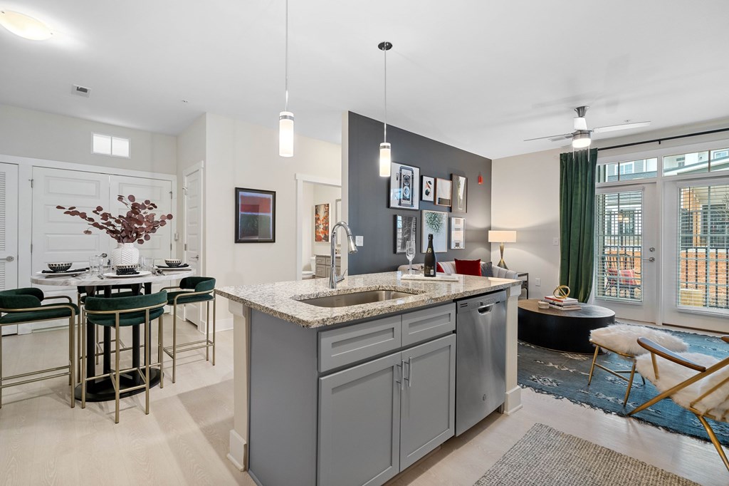 A kitchen with a table and chairs.