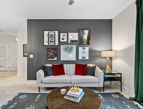 A living room with a grey couch and a coffee table.