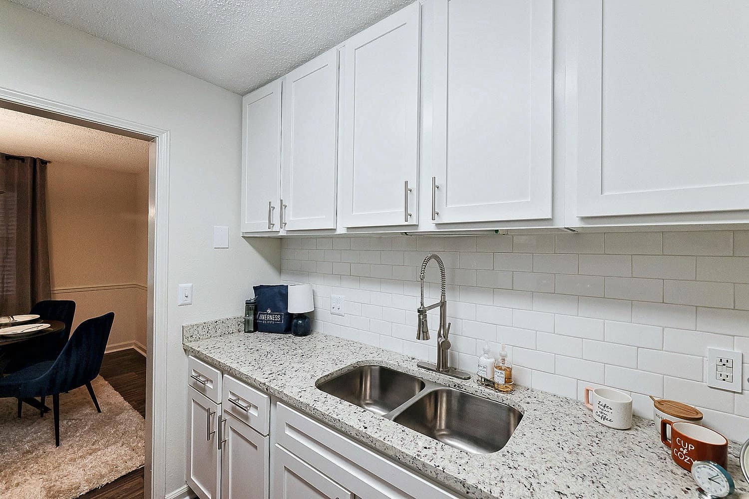 A kitchen with a sink and a chair.