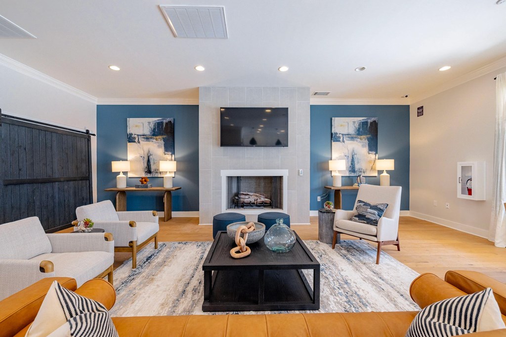 A living room with a fireplace and a television.