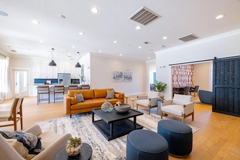 A modern living room with a black coffee table and a large window.