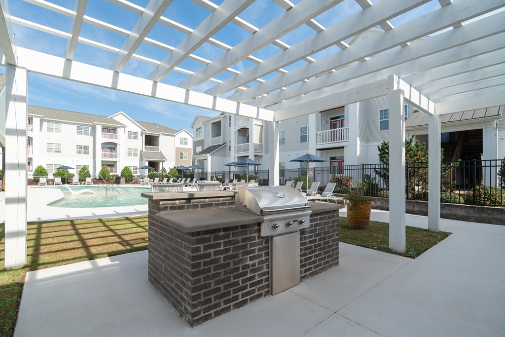 A patio with a grill and a pool table.